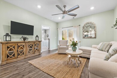 Living room with dark wood-type flooring and ceili