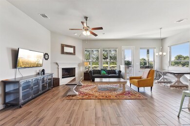 Living area featuring ceiling fan, wood finished 