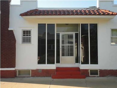 Driveway View of Side Porch from Dining Room