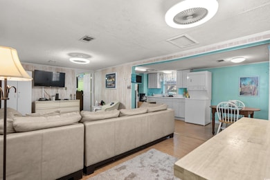 Living room featuring wood walls, a textured ceili