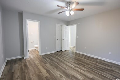 Unfurnished bedroom featuring dark wood-style floo