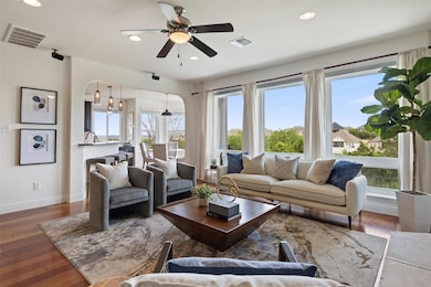 Living area with arched walkways, plenty of natur