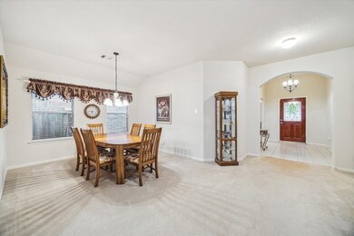 Spacious dining area with neutral walls and carpet