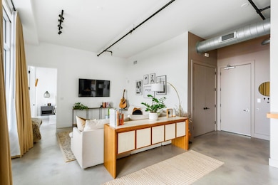 Living room with finished concrete floors and tra