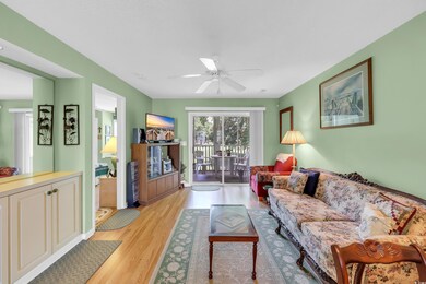 Living area featuring light wood-style floors and a ceiling fan