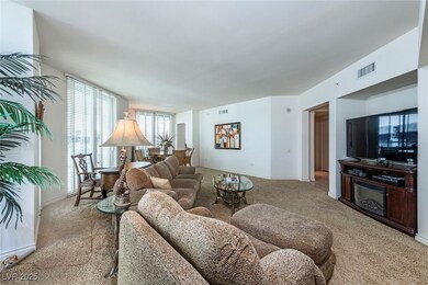 Living area with light colored carpet and baseboar