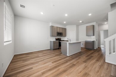 Kitchen featuring stainless steel appliances, gra
