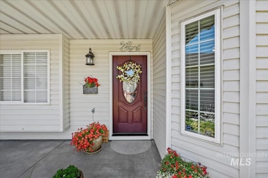 View of exterior entry with covered porch