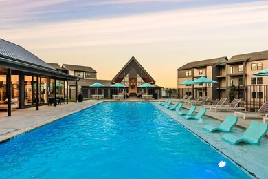 Pool at dusk featuring a patio area