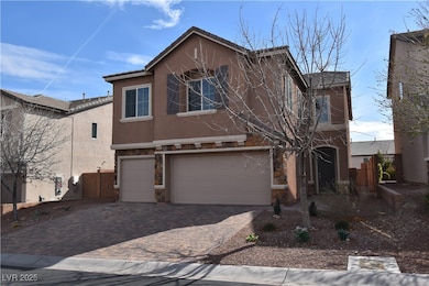 View of front of house with stucco siding, stone siding, decorative driveway, and a garage
