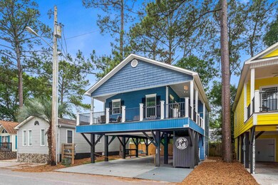 View of front of property featuring a carport and driveway