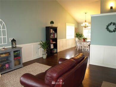 Handsome hardwood-type laminate floors grace the formal areas, along with vaulted ceiling, wains-coating, shadow-boxing and accent paint.