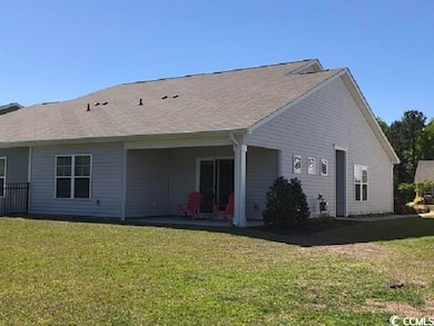 Rear view of property featuring a yard and a patio