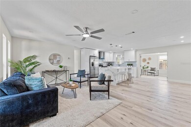 Bright open-concept living and kitchen area featuring brand new luxury vinyl plank flooring