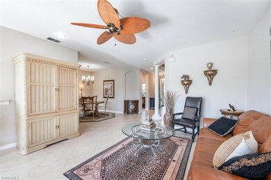Living room with ceiling fan with notable chandeli