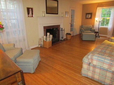 Hardwood Floor and Wood-burning Fireplace in Livin