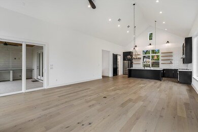 Unfurnished living room featuring high vaulted ce