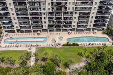 Aerial view of a pool area and apartment complex / building