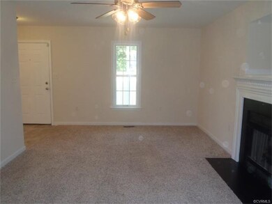 Great Room with gas fireplace and ceiling fan.
