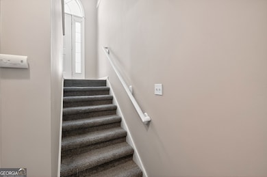 Stairs down to garage, laundry room