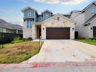 Contemporary home with stone siding, a garage, bo