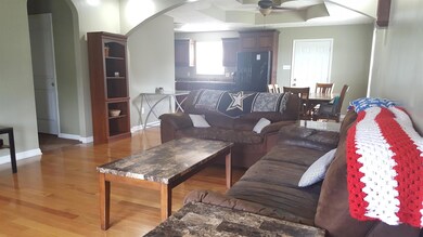 Another view of the living space with hardwood flooring.
