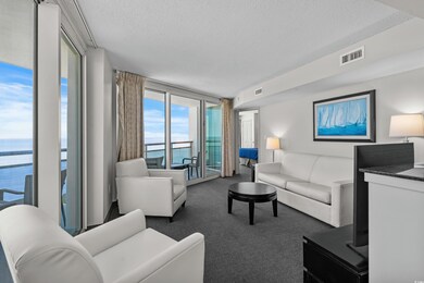 Carpeted living room featuring a textured ceiling,