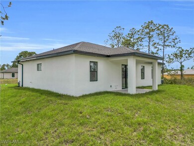 Back of property with a yard, a patio area, stucco