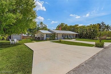 Ranch-style house with a front yard, driveway, and