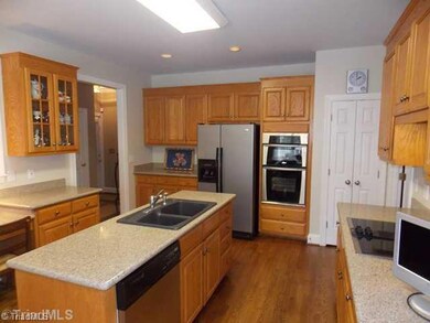 Kitchen. Large Kitchen with solid surface counter tops, hardwood floors, Built in Microwave and oven.  Cook top with downdraft.