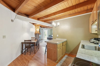 Kitchen with light wood-style floors, a wood ceili