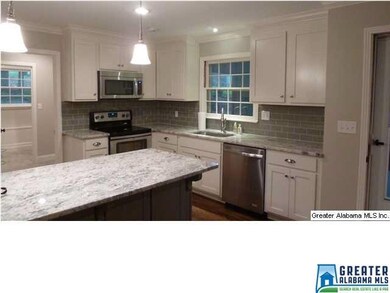another view of kitchen.  Door to screened porch o