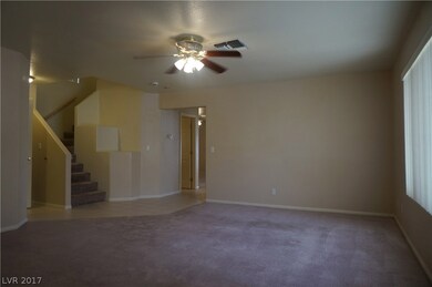 View of living room and staircase with shelving, f