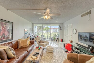 Living room and screened patio with views of water