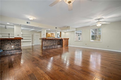 Family room featuring ceiling fan and wood-type fl