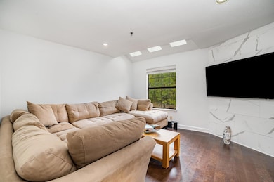 Living room featuring recessed lighting, a skyligh