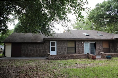 Back of property featuring brick siding,  and patio