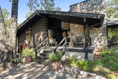 The home’s black & Austin stone exterior stands in bold contrast to the vibrant green woods.