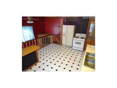 Kitchen overlooks family/bonus room with gas firep