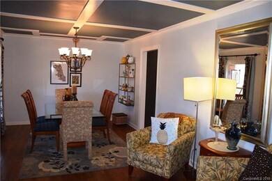 Lovely hardwoods and a decorative ceiling unite th