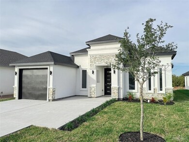 Prairie-style home featuring a front yard and a garage