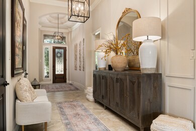 Designer light fixtures with half bath to the right as you walk through entrance.