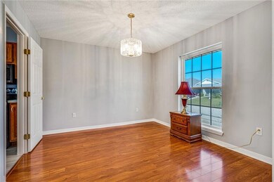 Formal dining room with wood floors and pretty cha