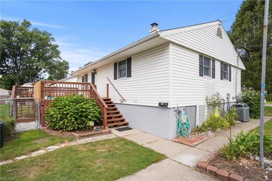View of side of home with central AC unit and a de