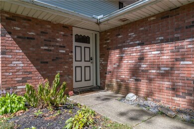 Doorway to property featuring brick siding