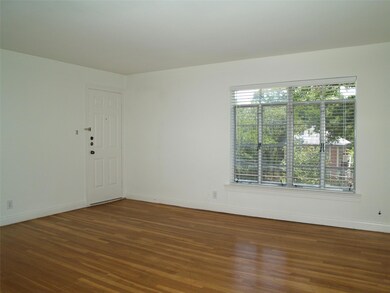 Empty room with wood finished floors and baseboar