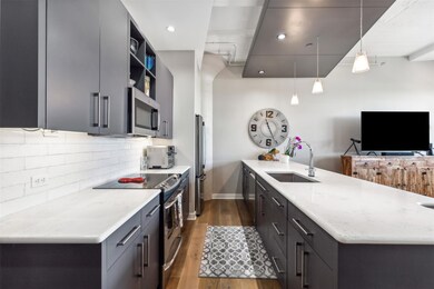 Kitchen featuring hanging light fixtures, applianc