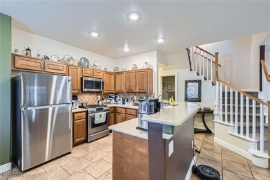 Kitchen with light colored countertops, wooden cab