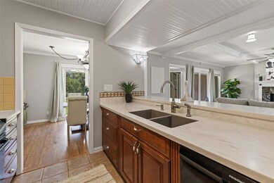Kitchen with dishwasher, light countertops, crown