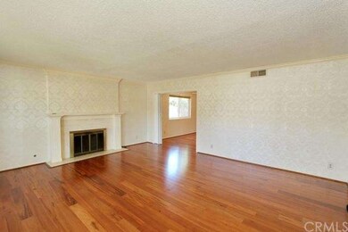 Living room with fireplace and opening to formal d